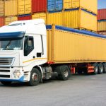 truck in harbor park with cargo containers